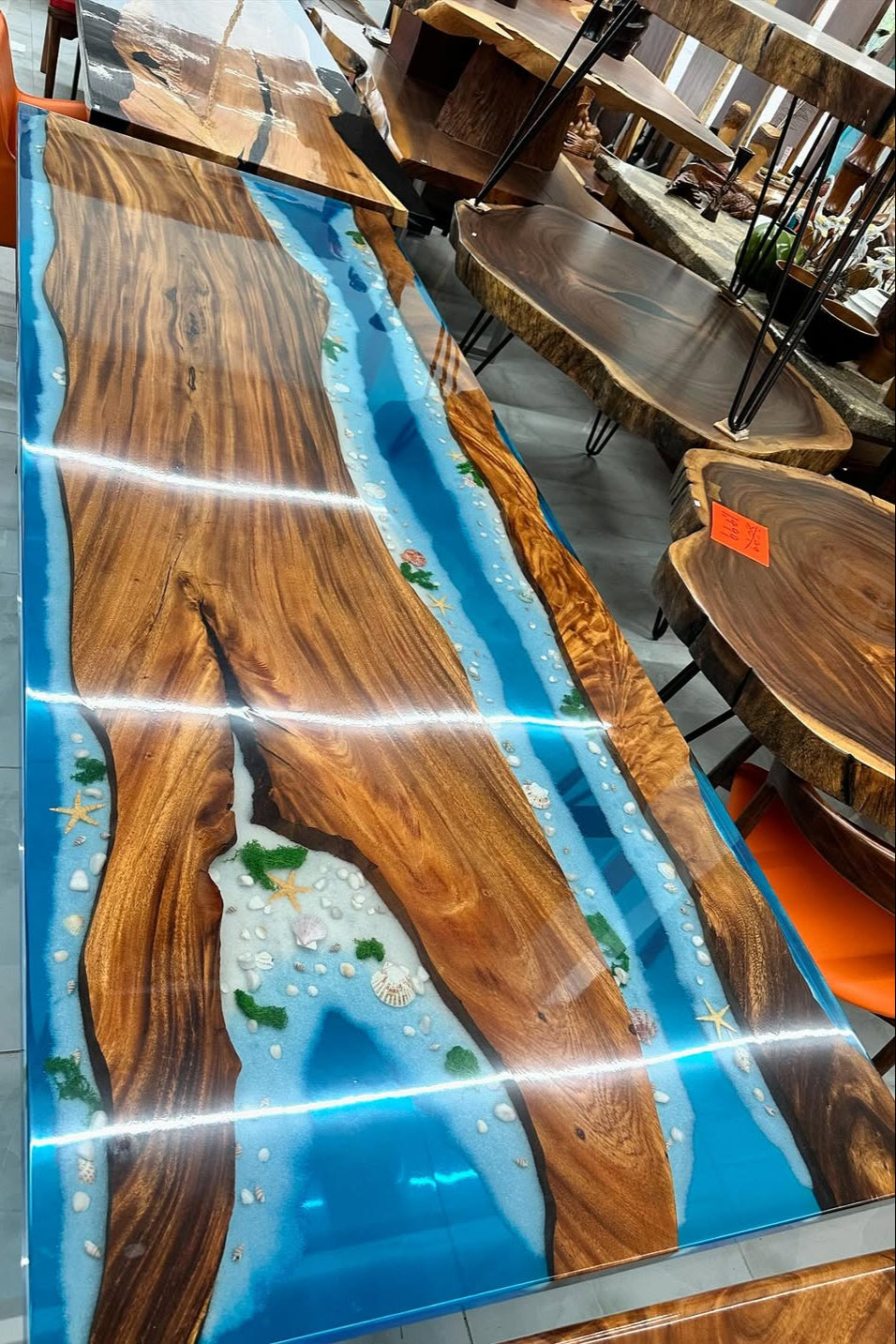 Wooden table with blue resin inlay in a showroom setting